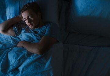 Photo of a man asleep in bed.